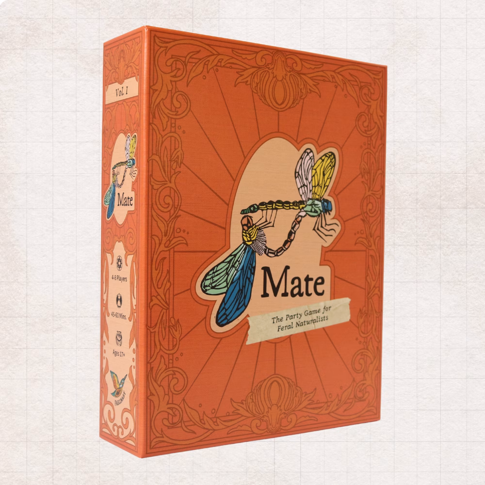 Mate: The Party Game for Feral Naturalists board game box is displayed. It is coral red and has an ornate victorian banner surrounding two colorful mating linocut dragonflies.